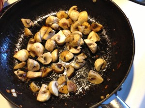 Mushrooms sizzling in skillet